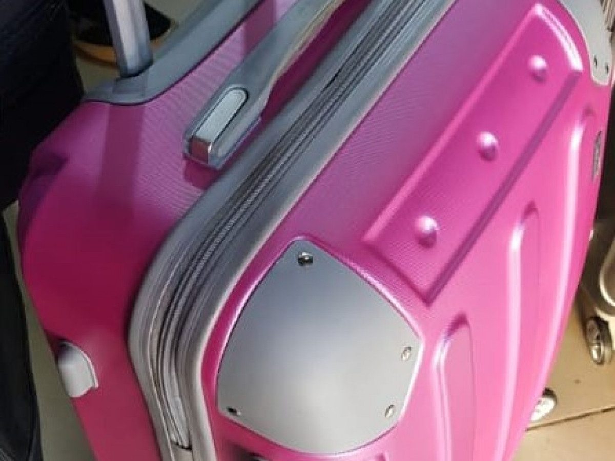 Pink suitcase trolley Stock Photo
